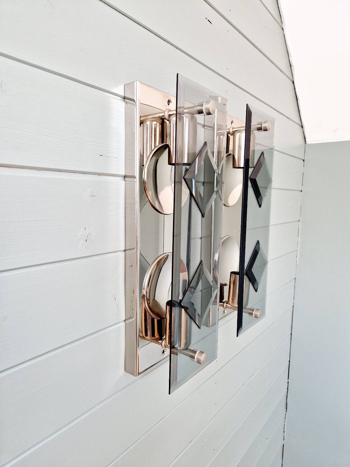 Pair of chrome metal and smoked glass wall sconces, 1970s.