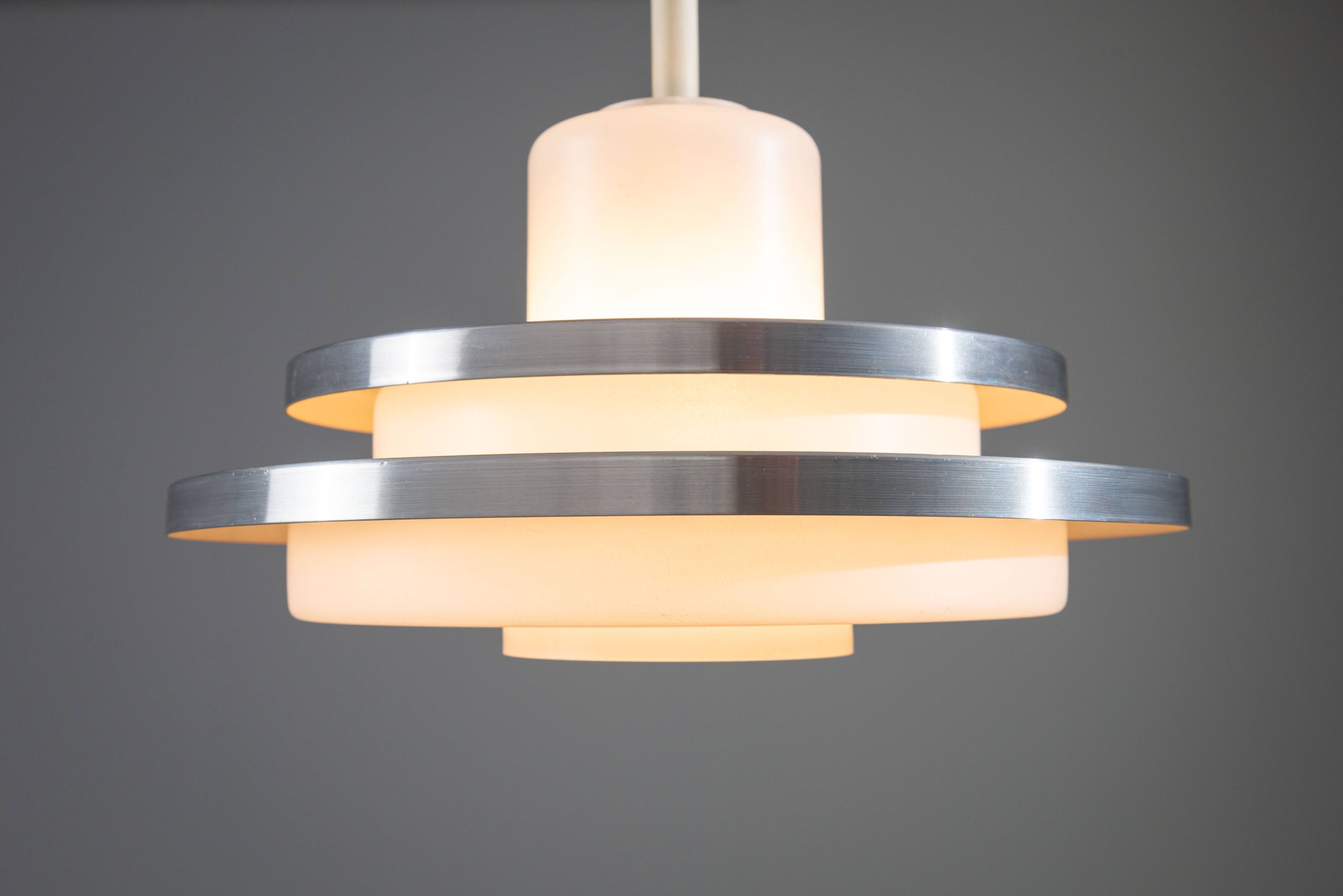 Doria pendant in opal glass with decorative aluminium discs