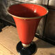 Cut vase on foot in red and black metal
