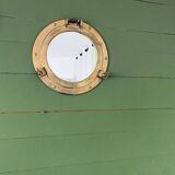 Porthole mirror in gilded brass