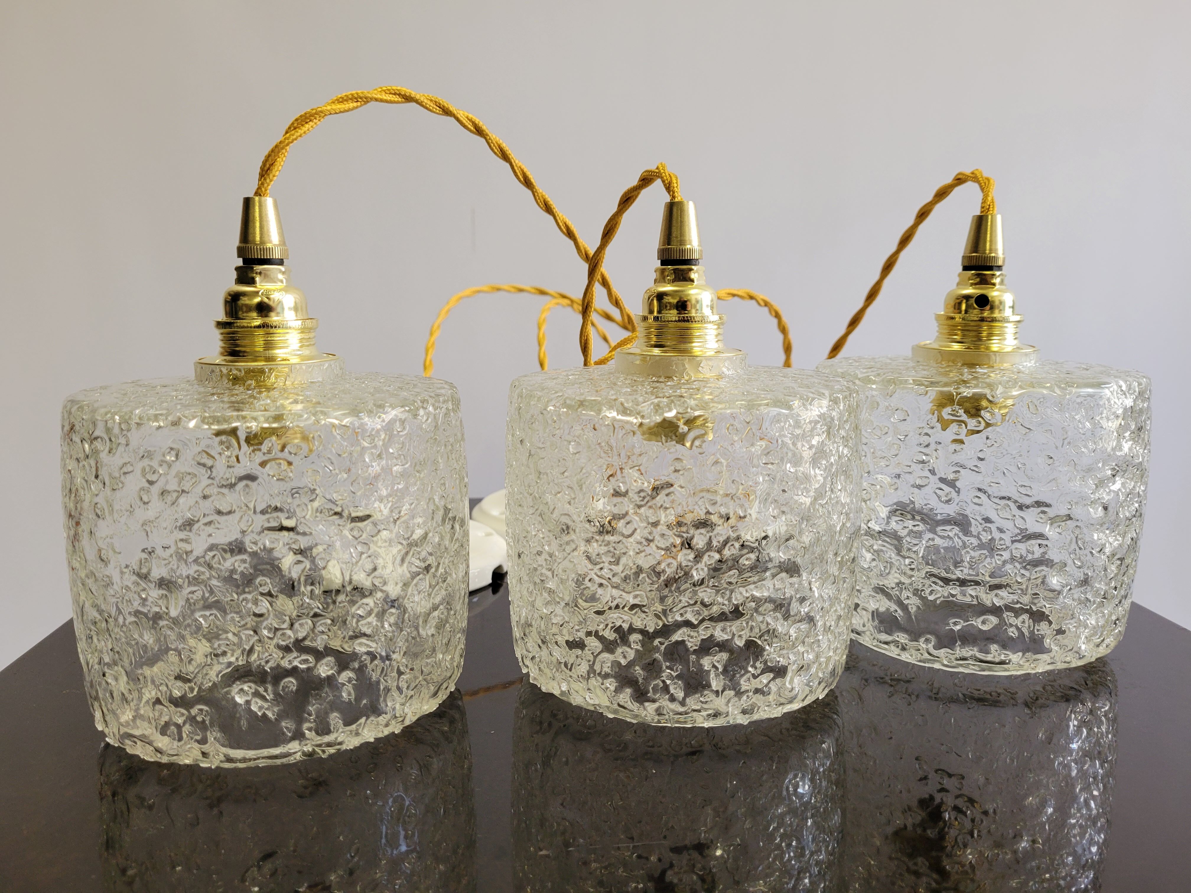 Trio of scrambled glass pendant lamps