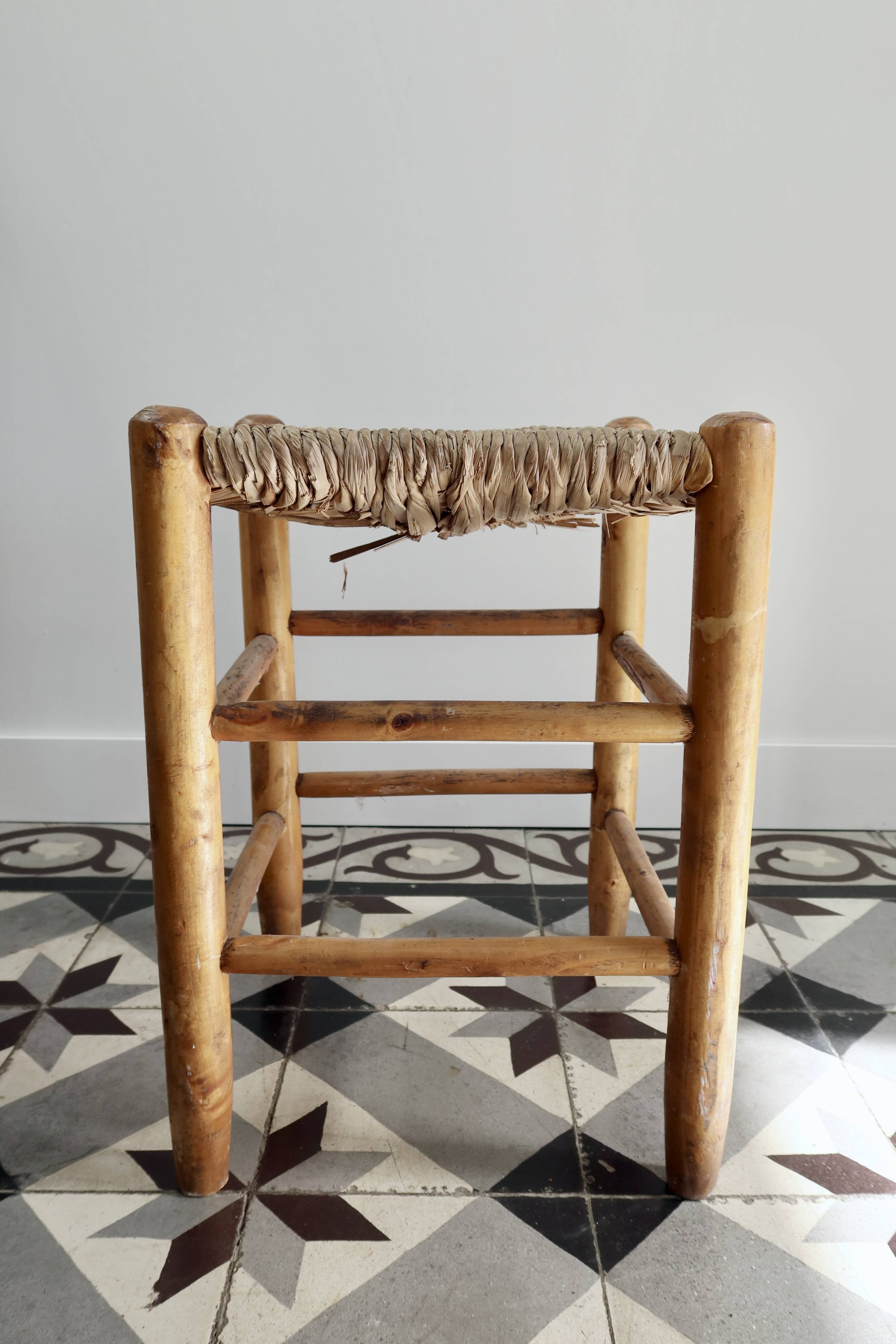 Vintage low stool in wood, honey yellow tones – Woven seat