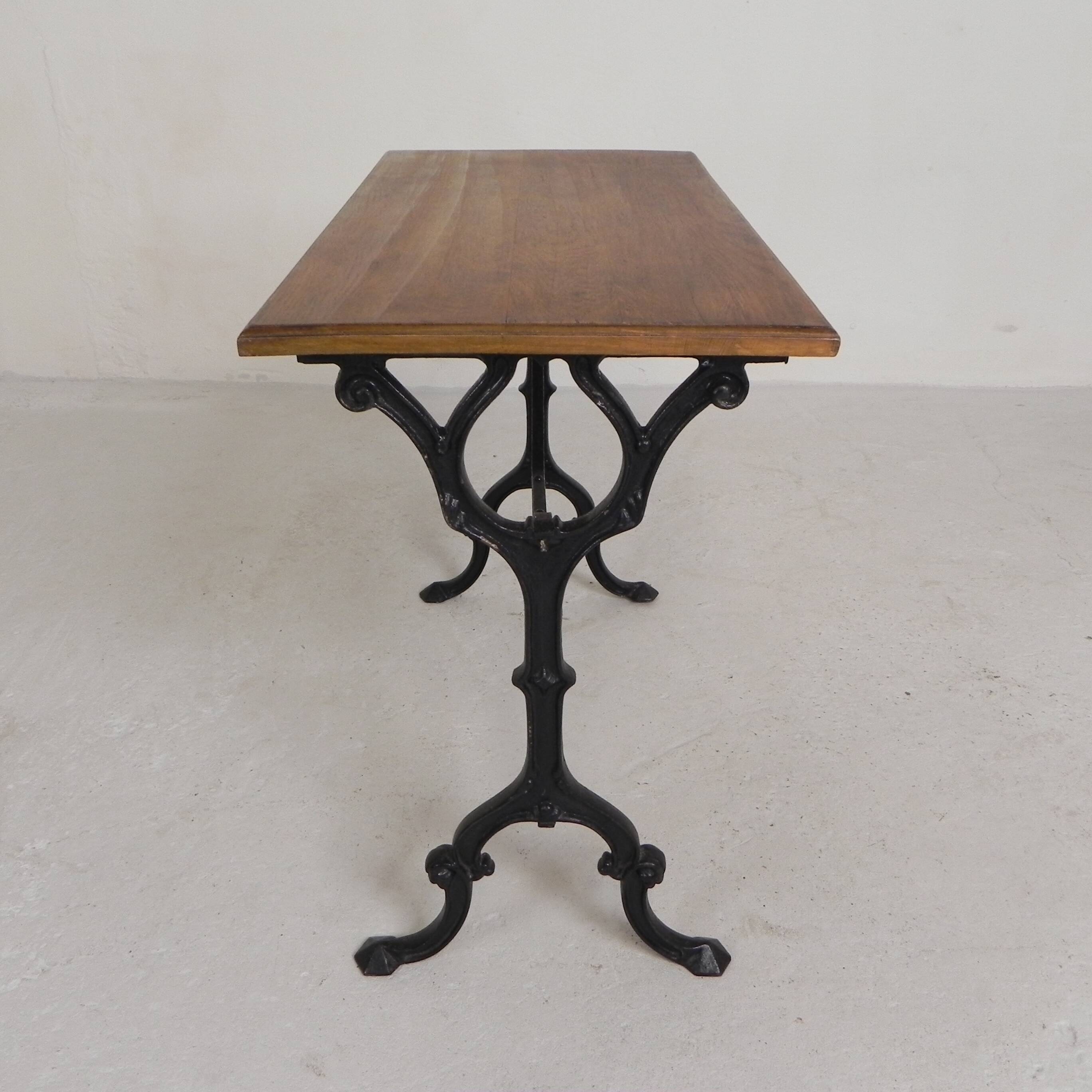 Bistro table with an oak top on a cast iron base, 1930s.