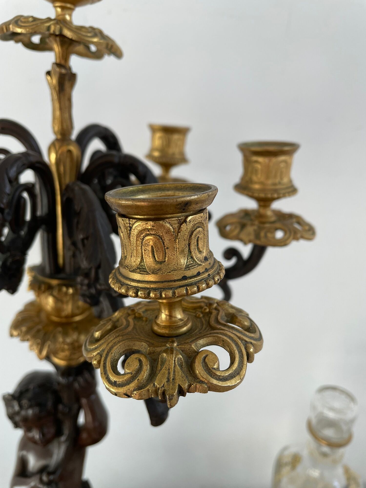 Candelabra with cherub in patinated bronze