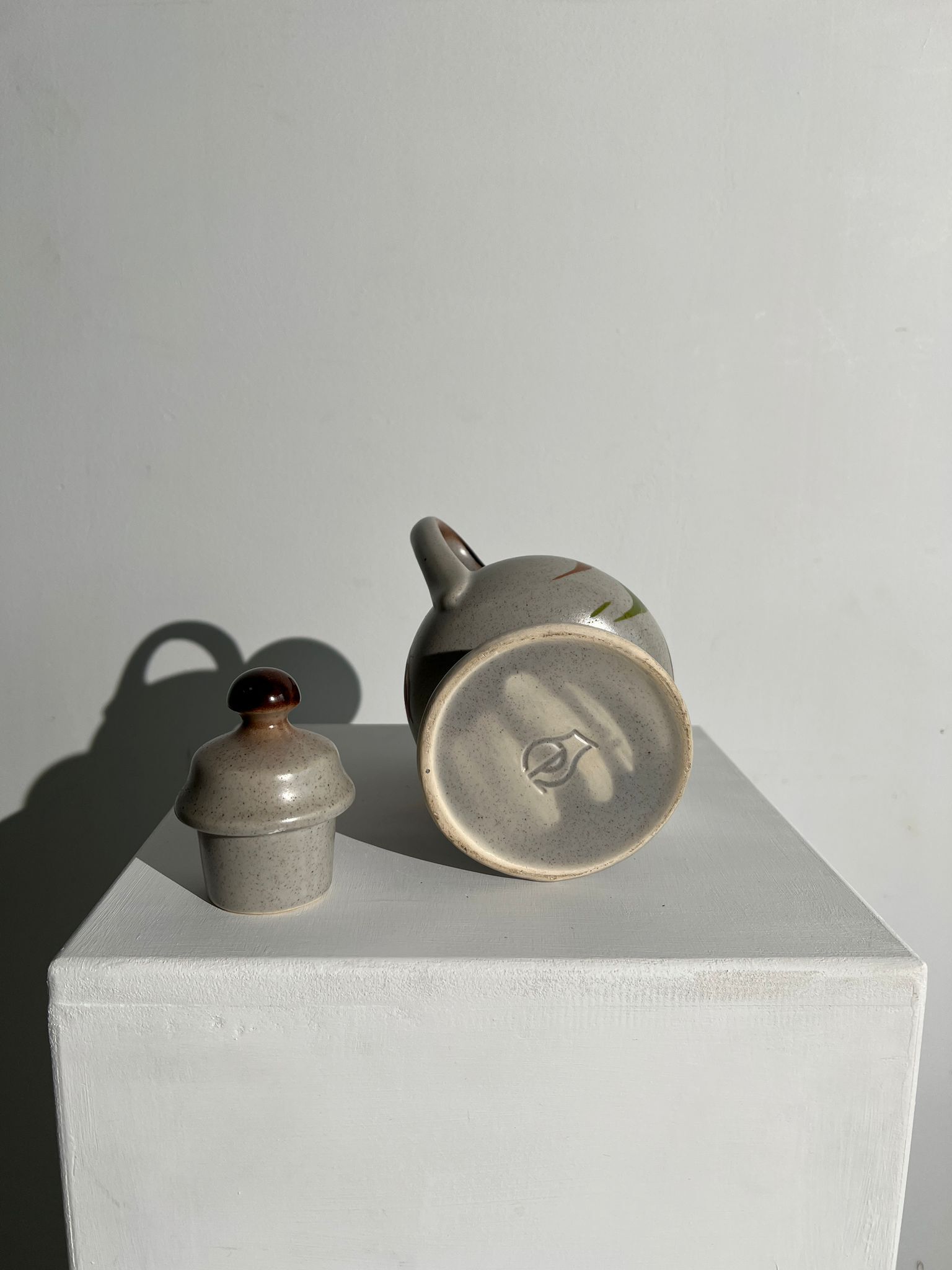 Vintage stoneware teapot with flower and fruit patterns