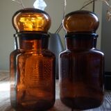 Duo of vintage apothecary bottles in amber glass