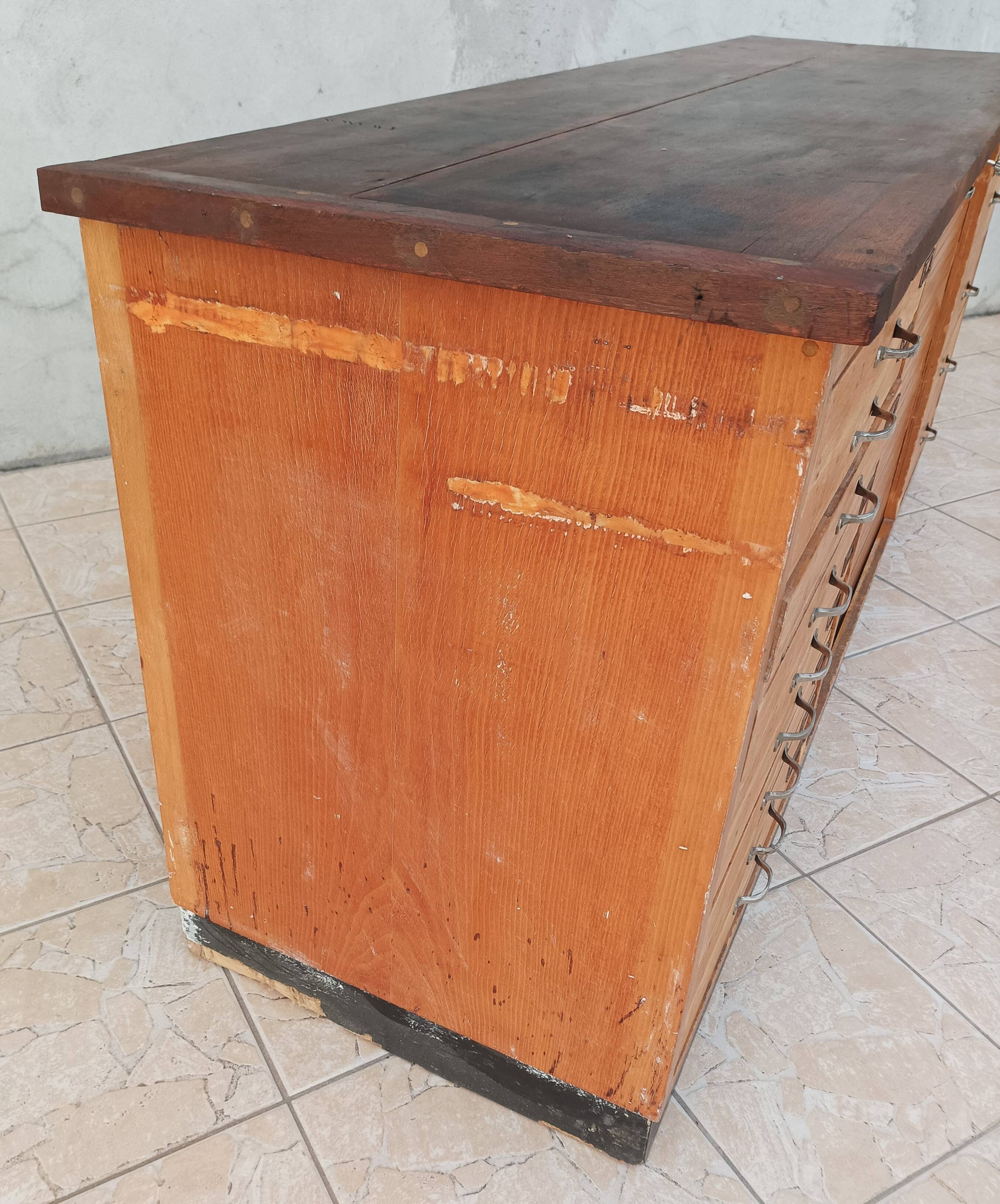Workshop furniture with drawers and curtain in beech and walnut.