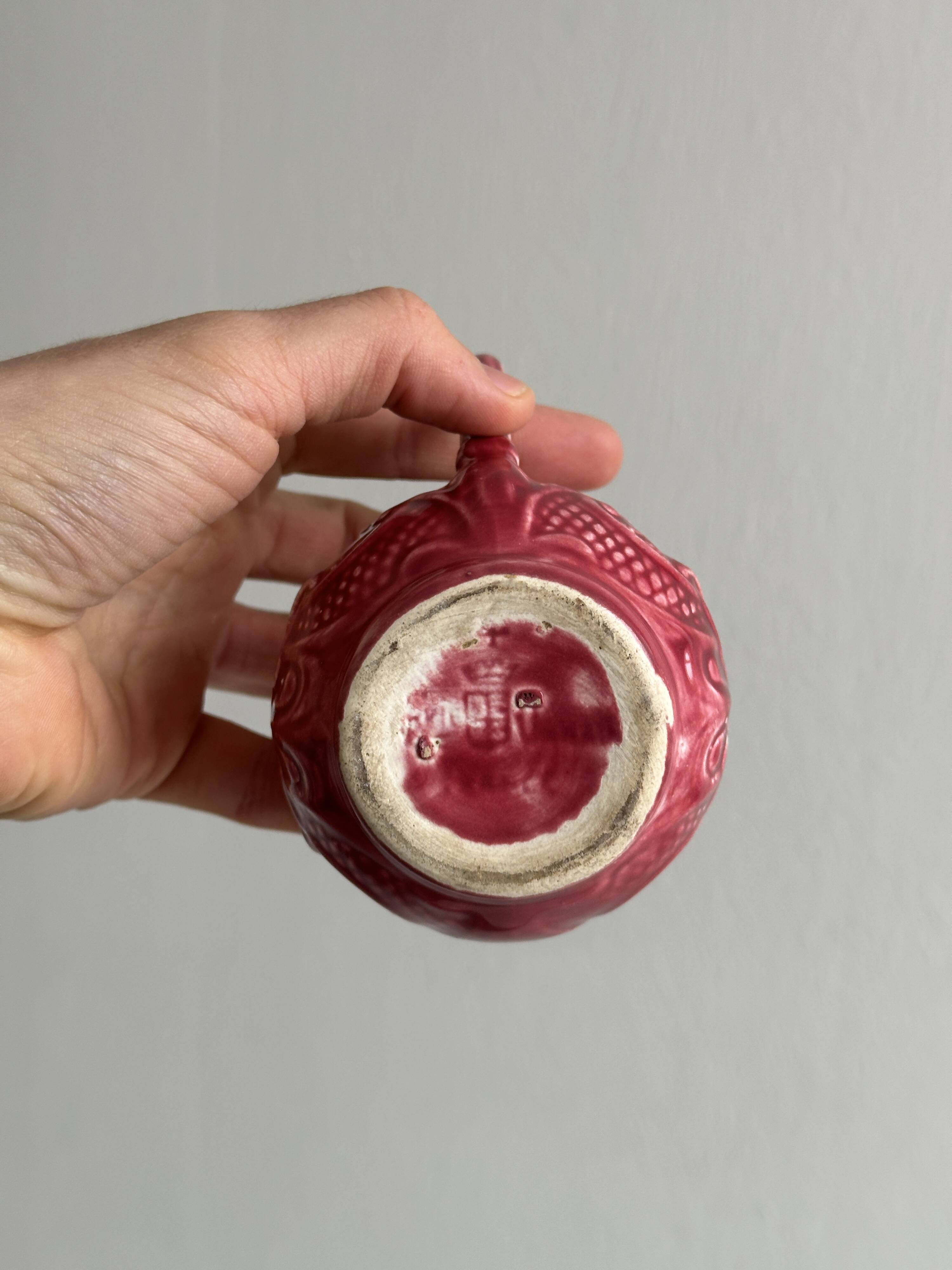 Red ceramic milk jug