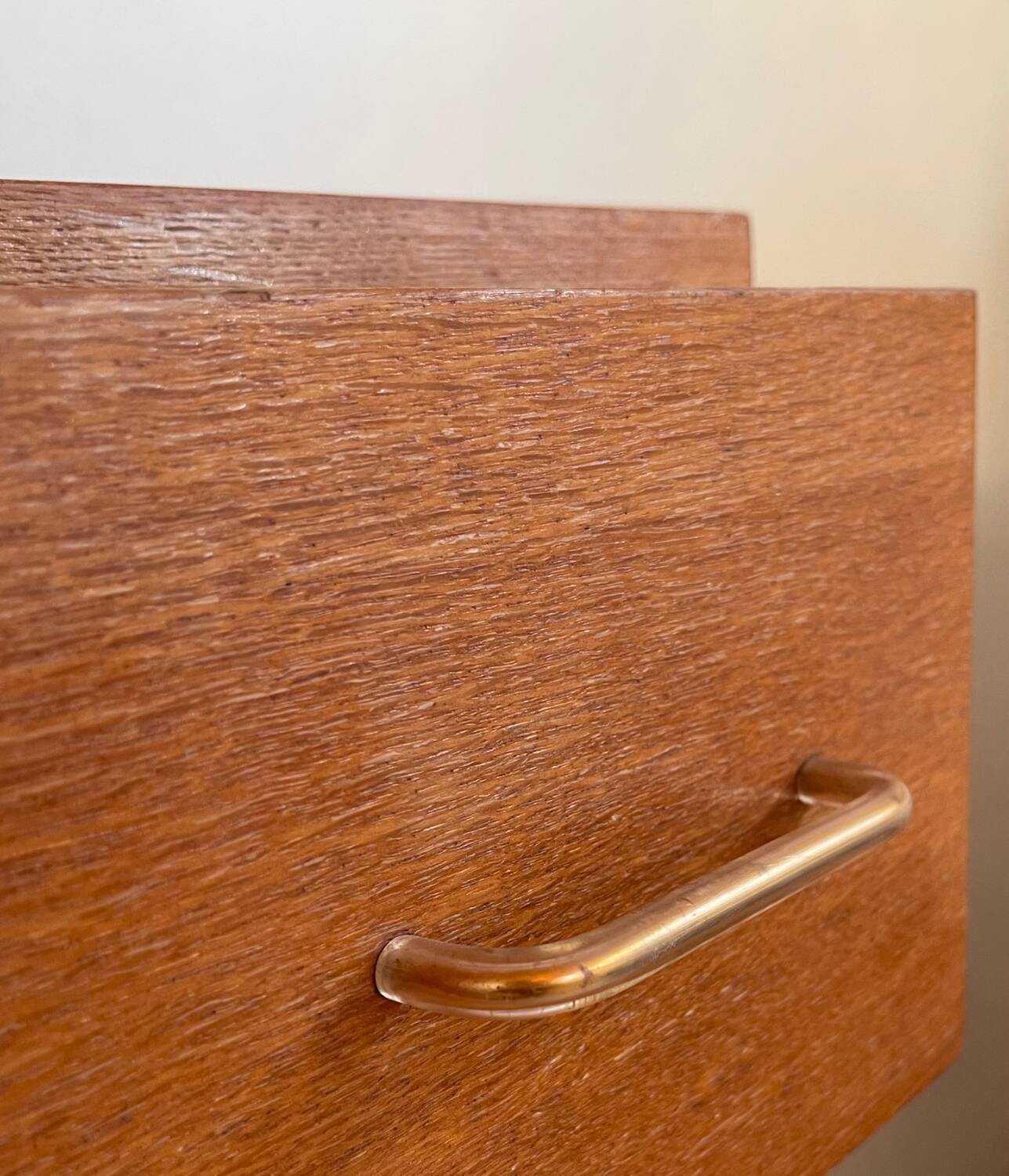 Vintage 1960s chest of drawers with covered handles.