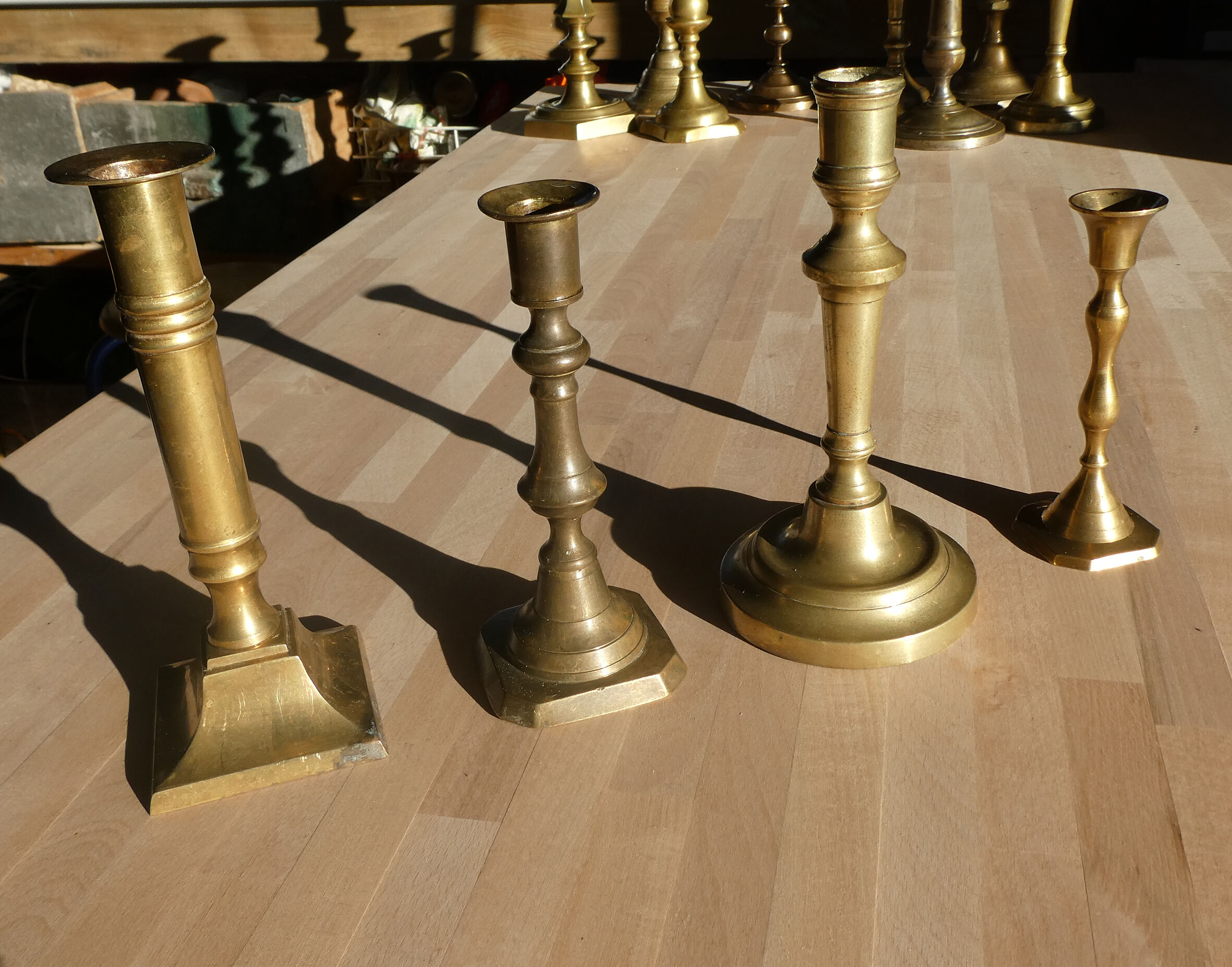 Set of 4 old candle holders in golden brass