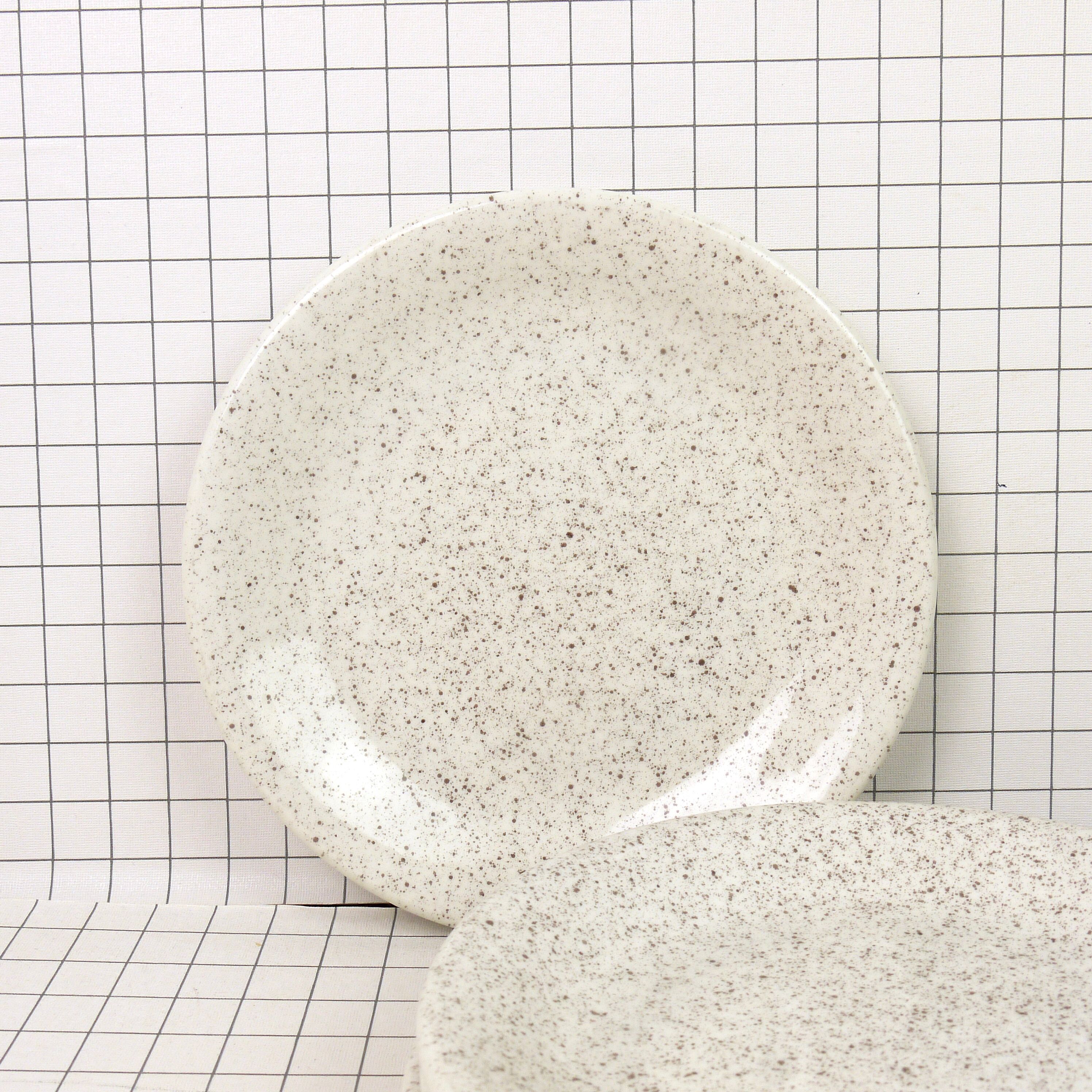 Four Ceraminter dessert plates