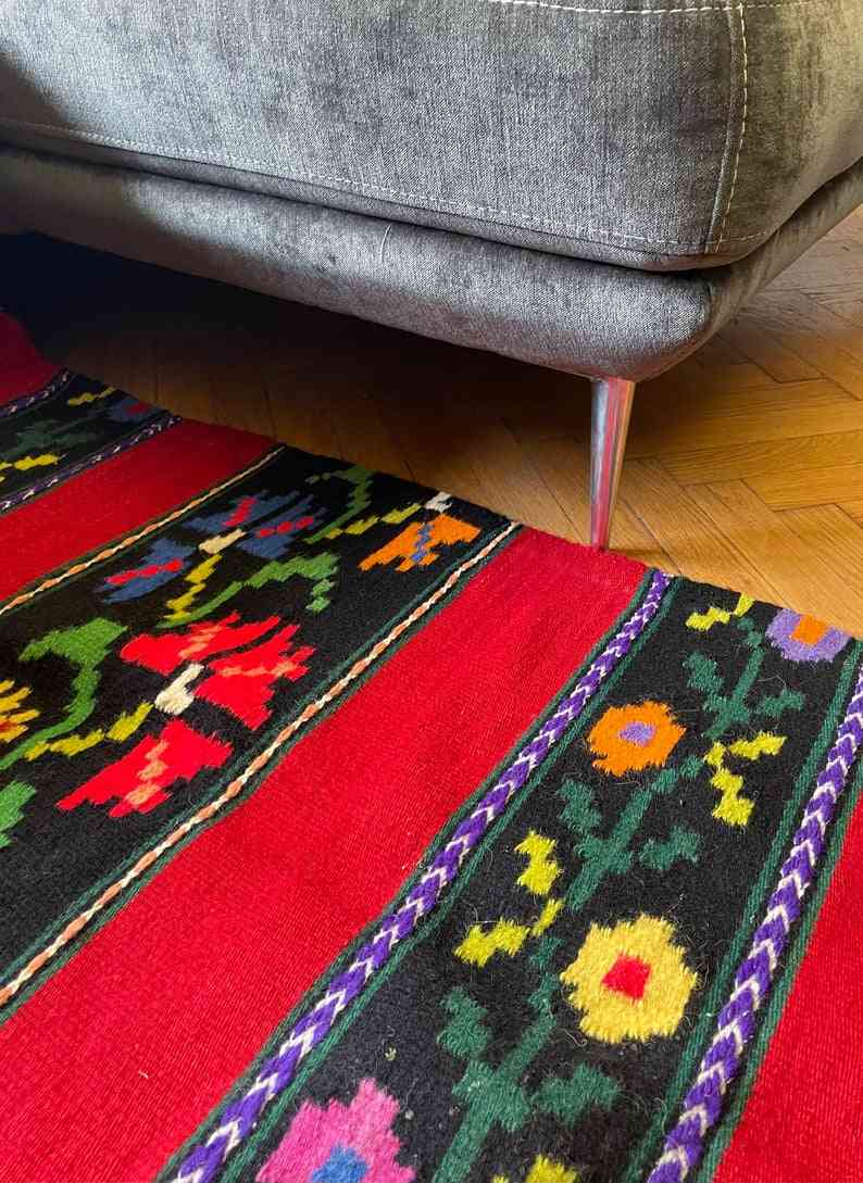 Romanian wool rug, red background with delicate colourful flowers