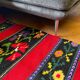 Romanian wool rug, red background with delicate colourful flowers