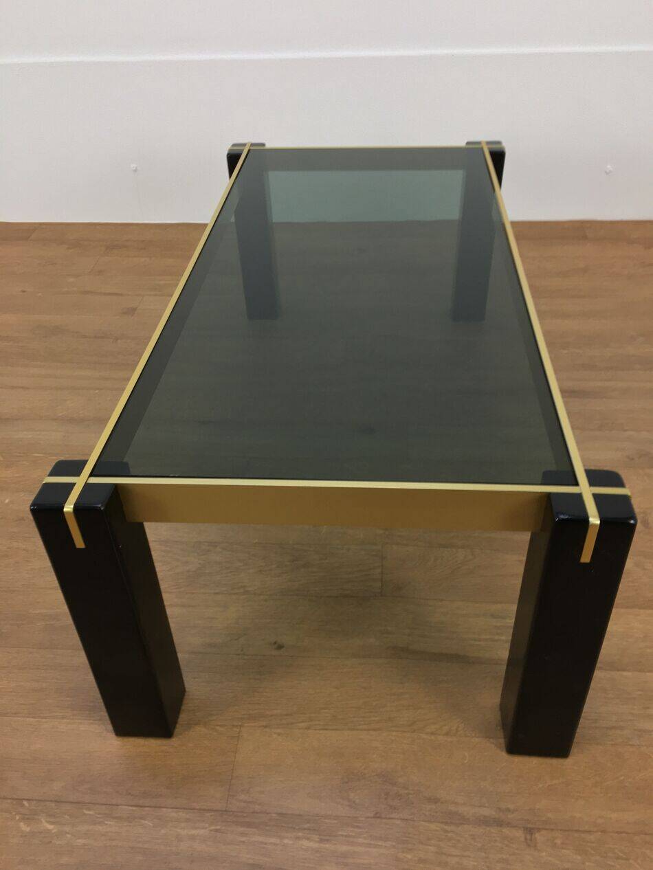 Italian coffee table from the 70s, smoked glass, black and gold lacquered wood.