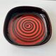 Large decorative ceramic catchall with red and black spiral pattern.