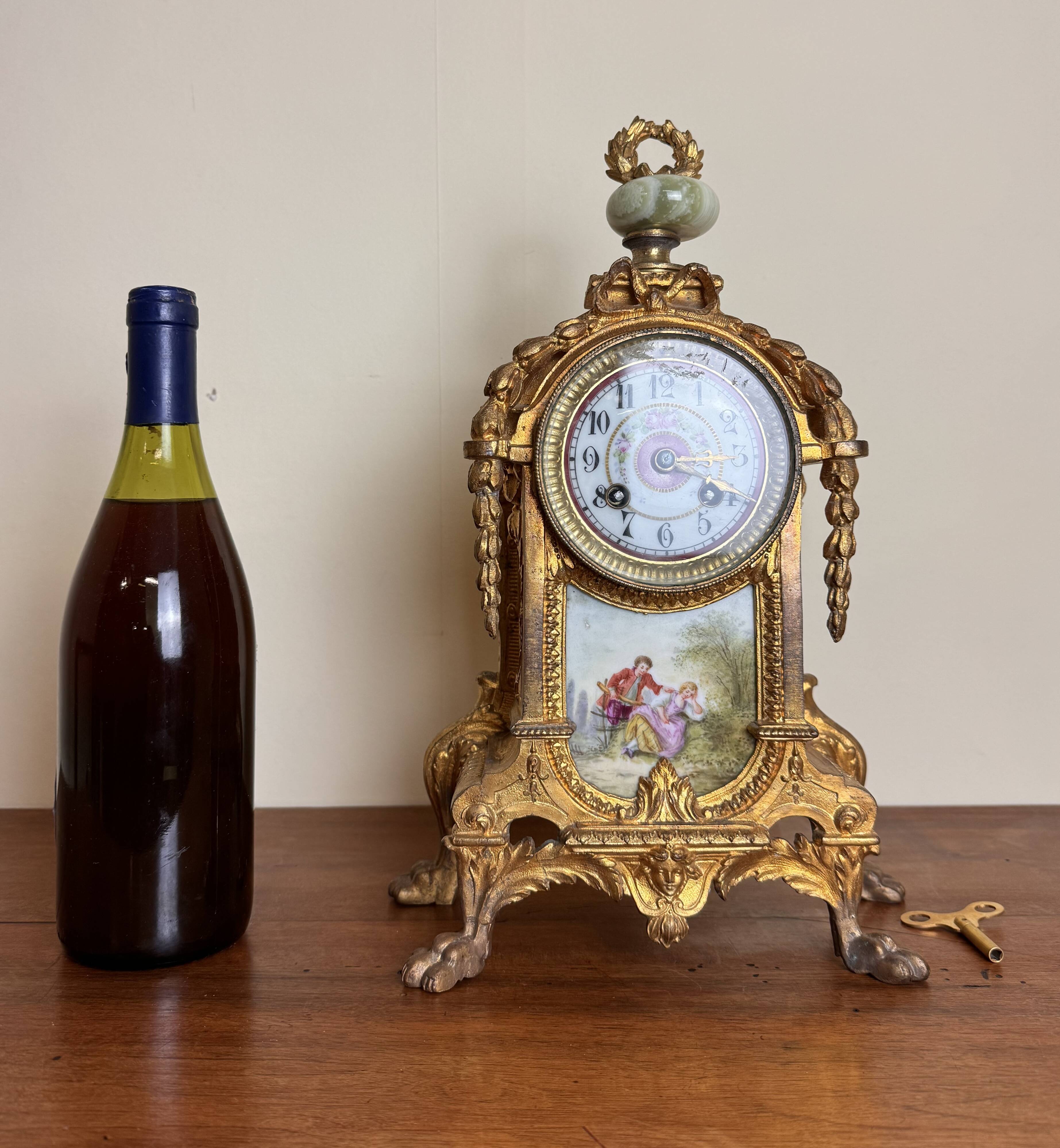Napoleon III clock in gilded bronze and porcelain plates decorated and painted by hand