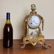 Napoleon III clock in gilded bronze and porcelain plates decorated and painted by hand