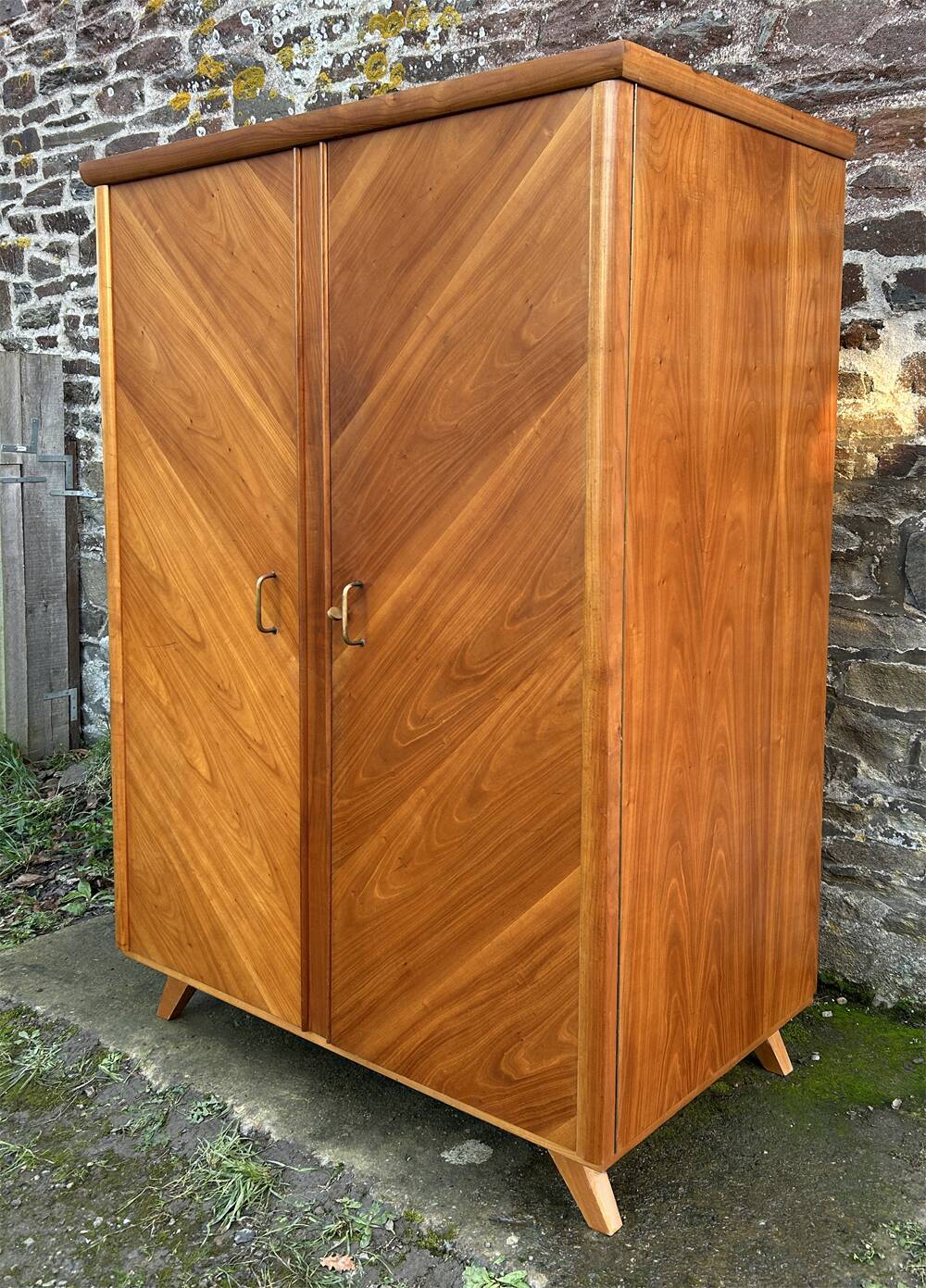Mid-century wardrobe from the 1960s in wood, with a chevron front and tapered legs.
