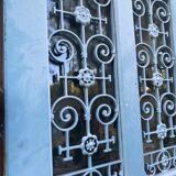Entrance door in solid oak, cast iron grille, 1930s