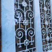 Entrance door in solid oak, cast iron grille, 1930s