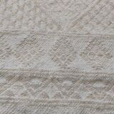 Hand-woven rug in natural wool