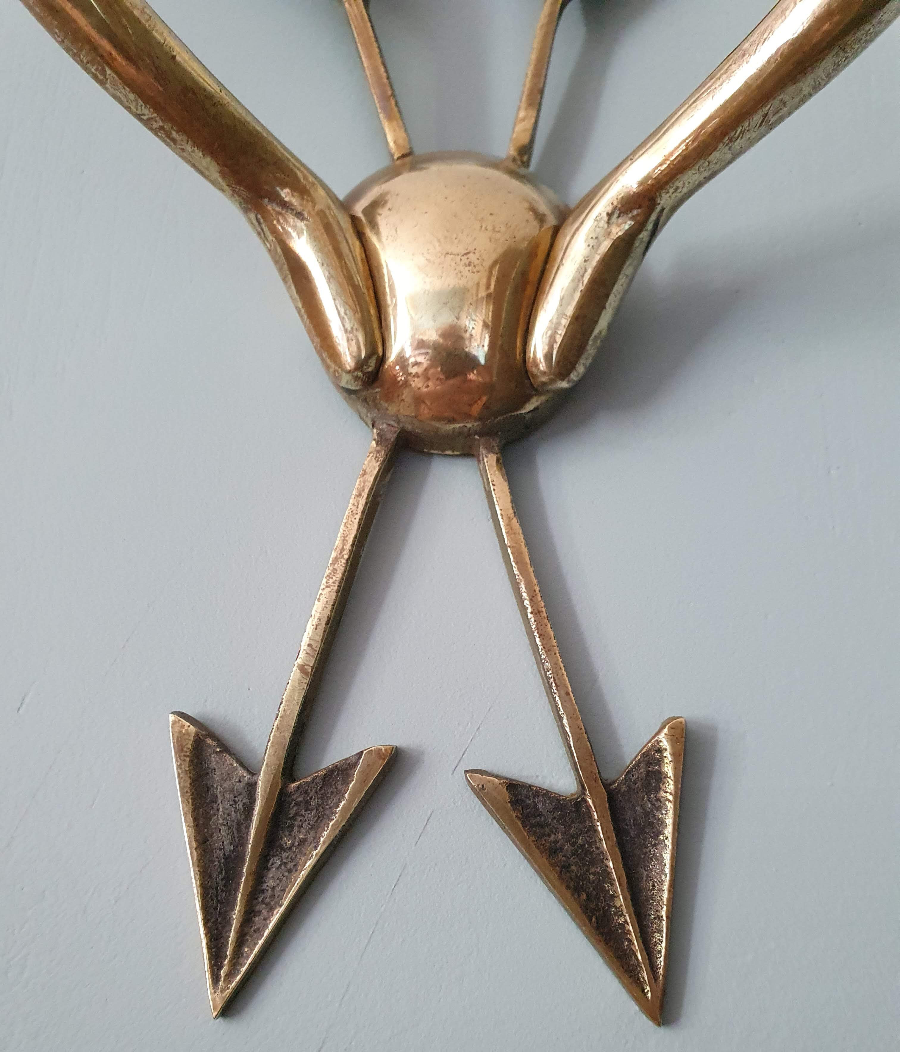 Vintage wall lamp decorated with bronze arrows