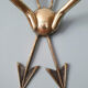 Vintage wall lamp decorated with bronze arrows