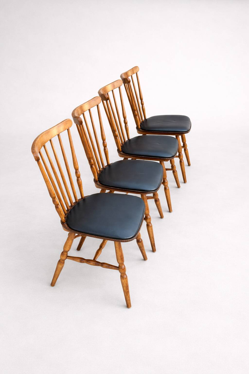 Set of 4 Baumann "Menuet" chairs – stained beech and black faux leather – French design