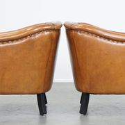 Set of 2 sheep leather club chairs finished with black piping