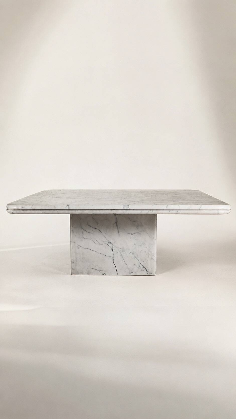 Table with a solid Carrara marble base.