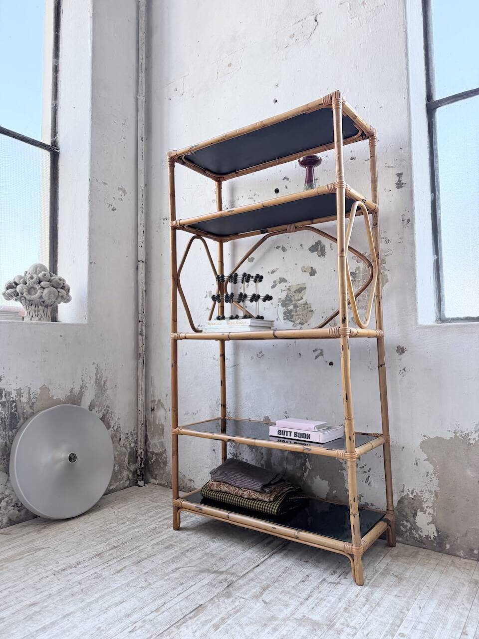 Rattan bookshelf and black glasses