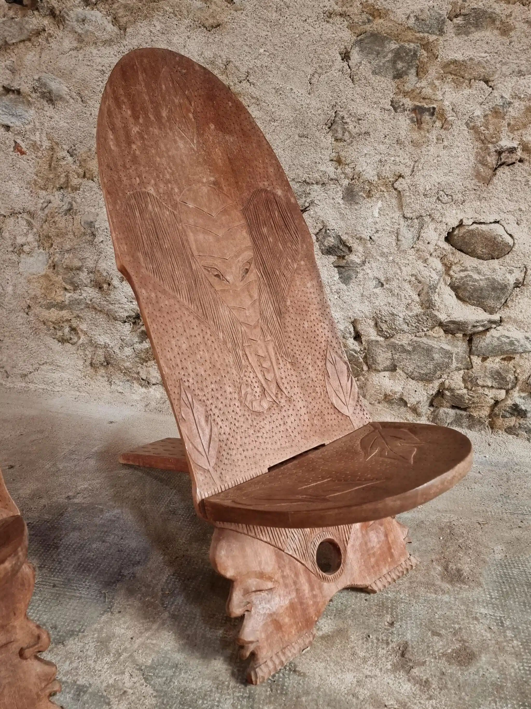 Pair of hand-carved wooden folding chairs – African origin, animal and face motifs, mid-20th century