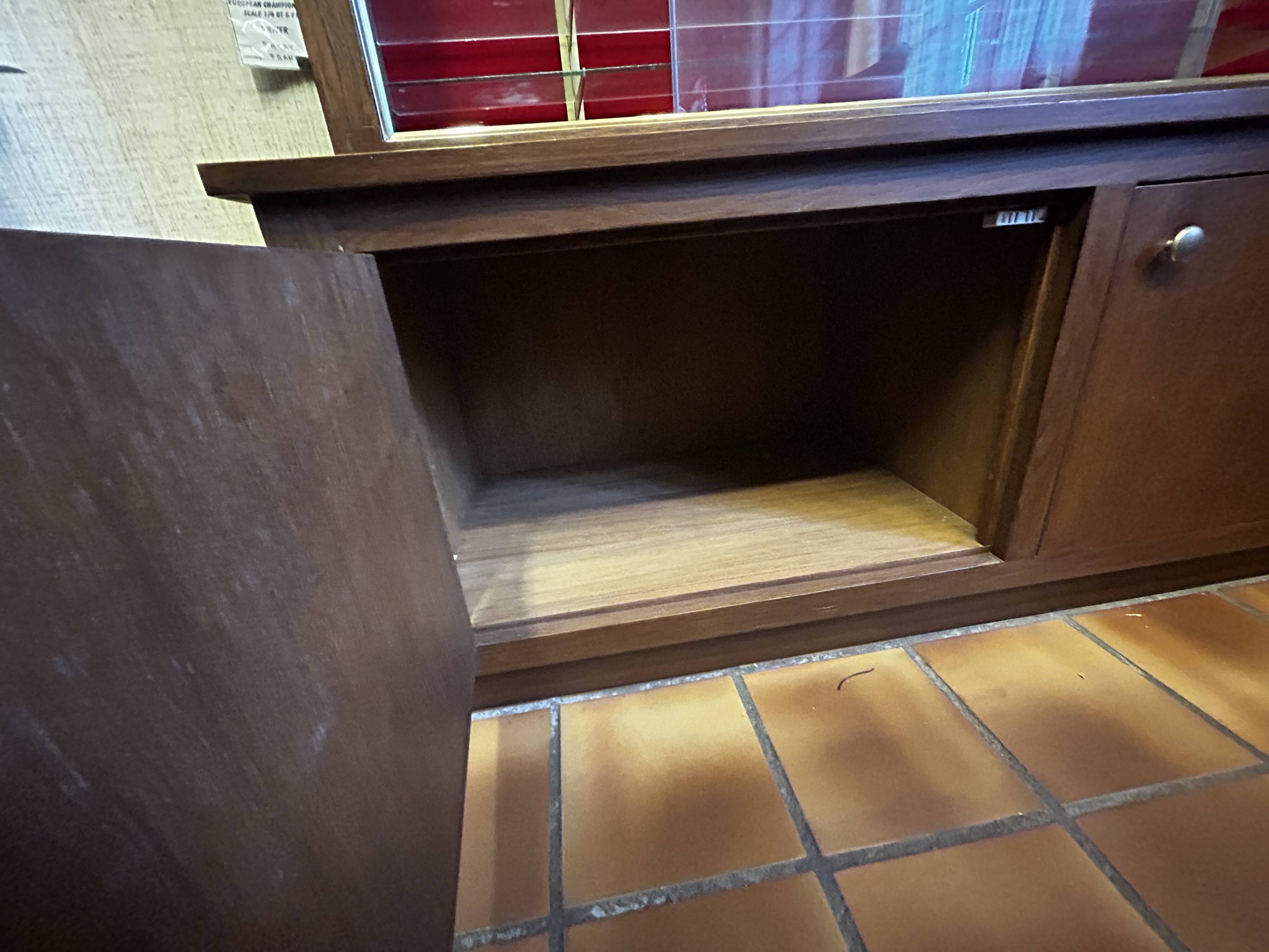 Large vintage display cabinet in wood and glass – red background, 15 shelves
