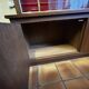 Large vintage display cabinet in wood and glass – red background, 15 shelves