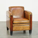 Sheepskin Art Deco design armchair with beautiful wooden details and black piping