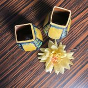 A pair of green and yellow vases