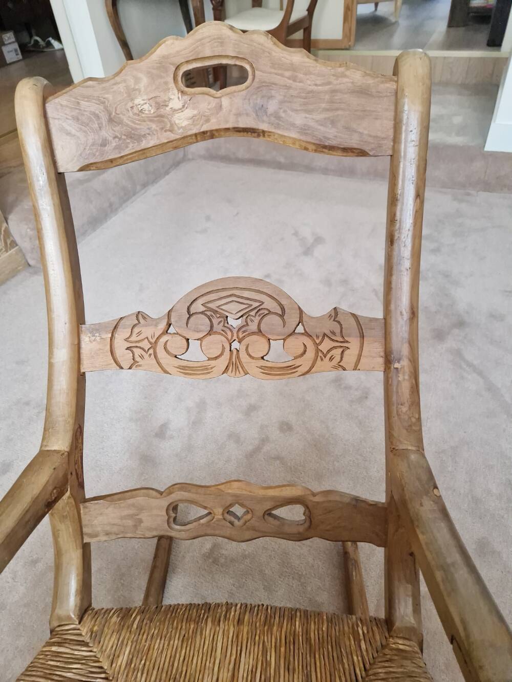Oak rocking chair with a straw seat.