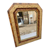 19th-century mirror with faux wood and gilded stucco.