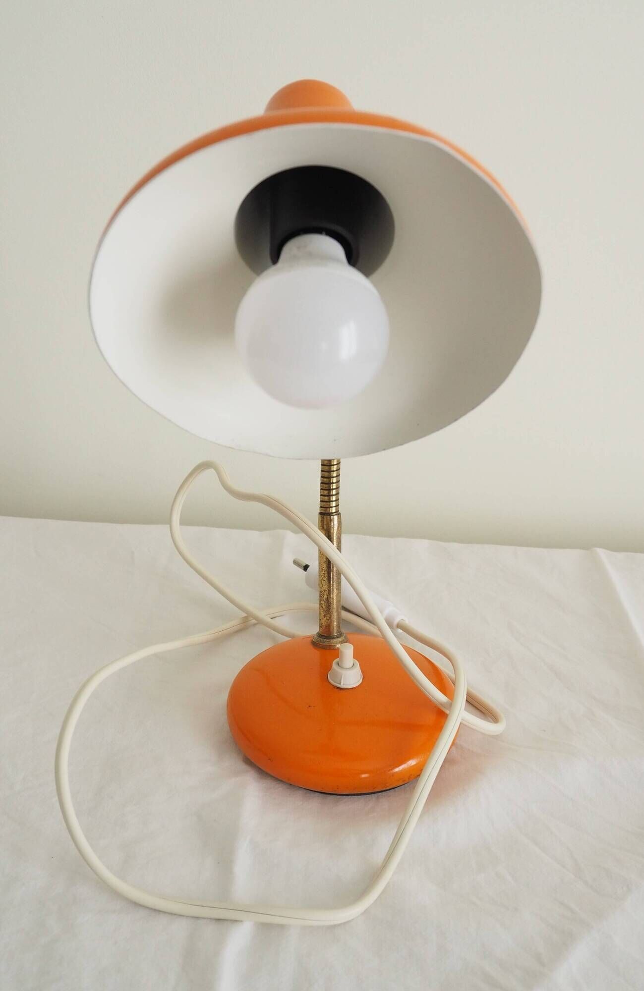 Orange colored metal desk lamp from the 1960s-1970s