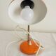 Orange colored metal desk lamp from the 1960s-1970s