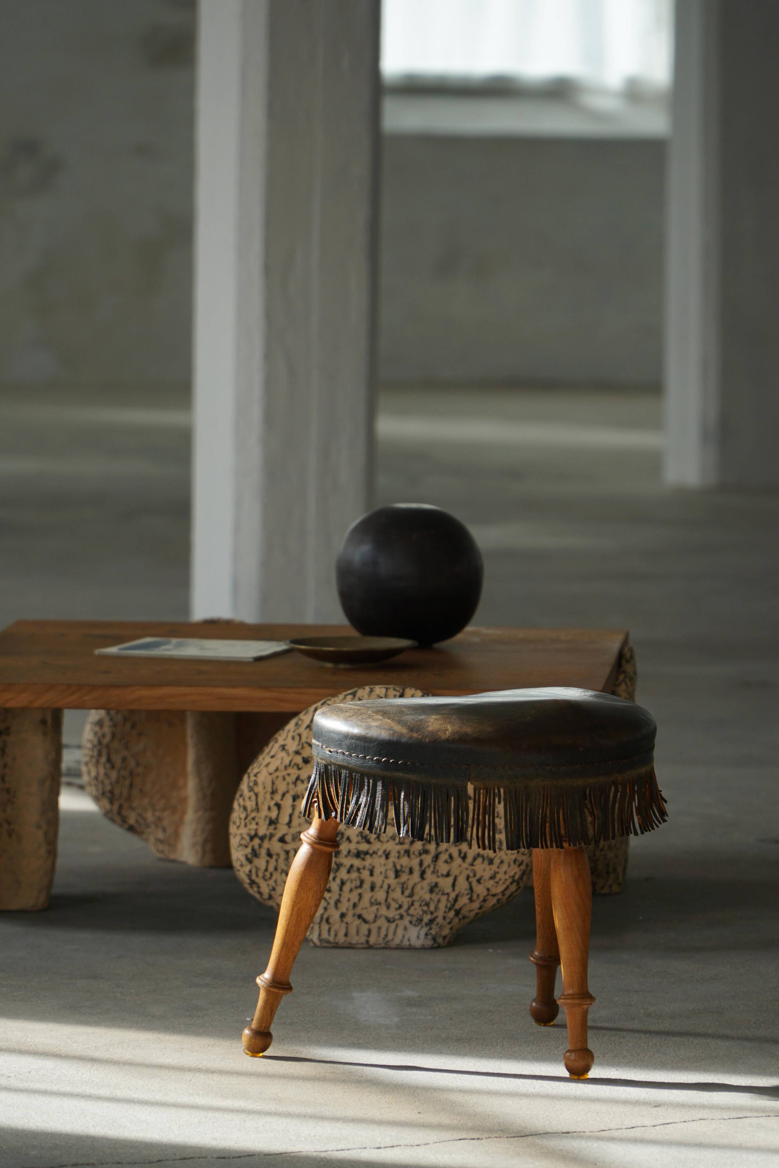 Danish oak tripod stool from the early 20th century with leather fringe, 1930s.