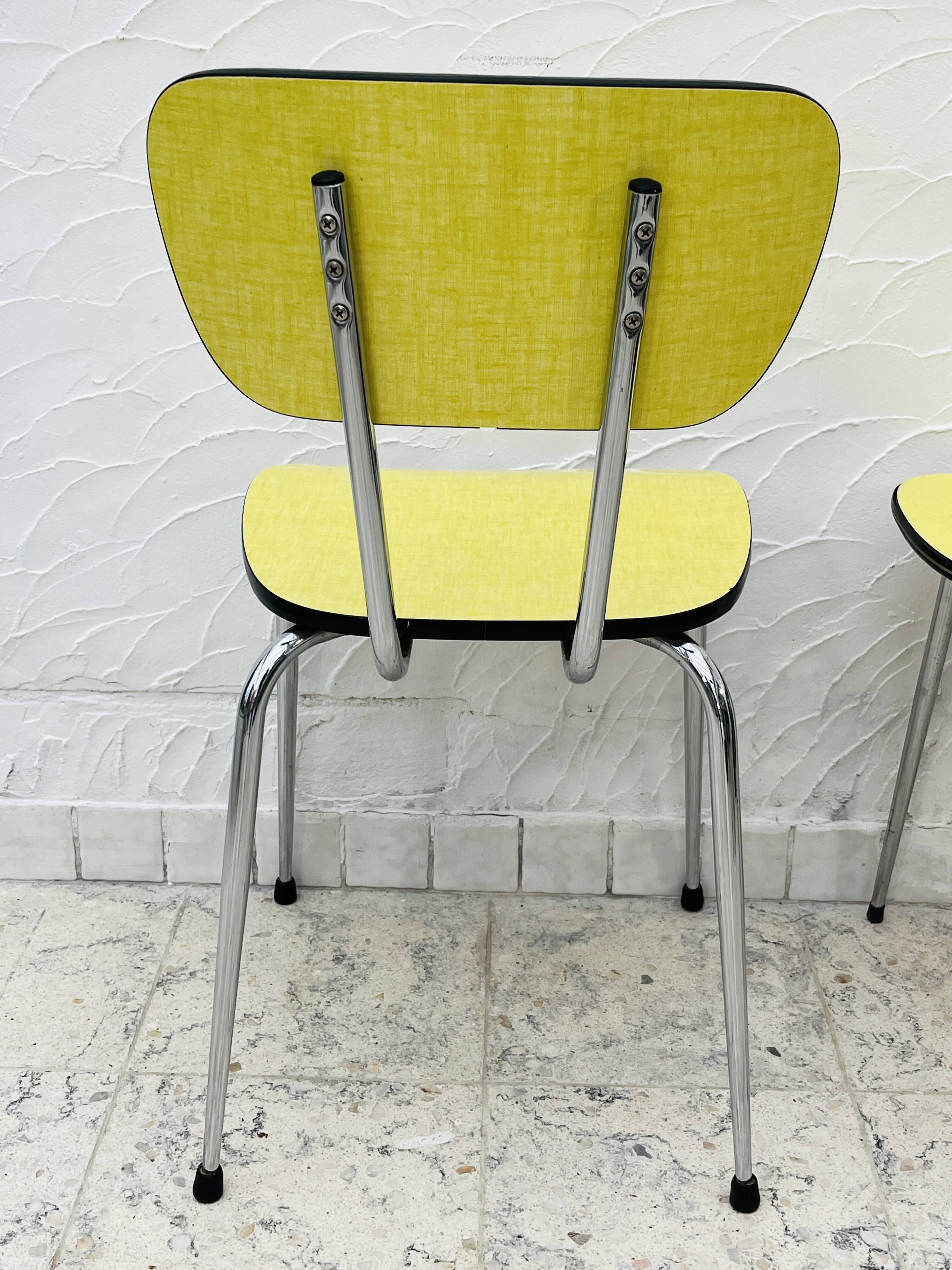 Pair of vintage yellow chrome Formica kitchen chairs.
