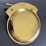 Round brass pocket tray with club and golf ball decoration.
