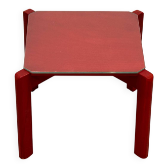 Small red wooden coffee table with glass.