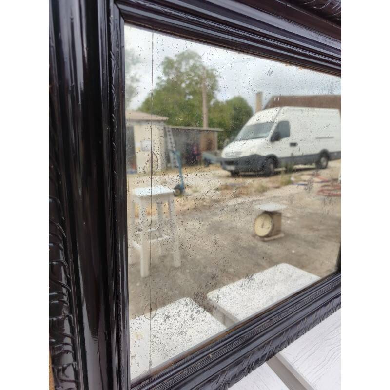 Black lacquered wood mirror "originally punctured"