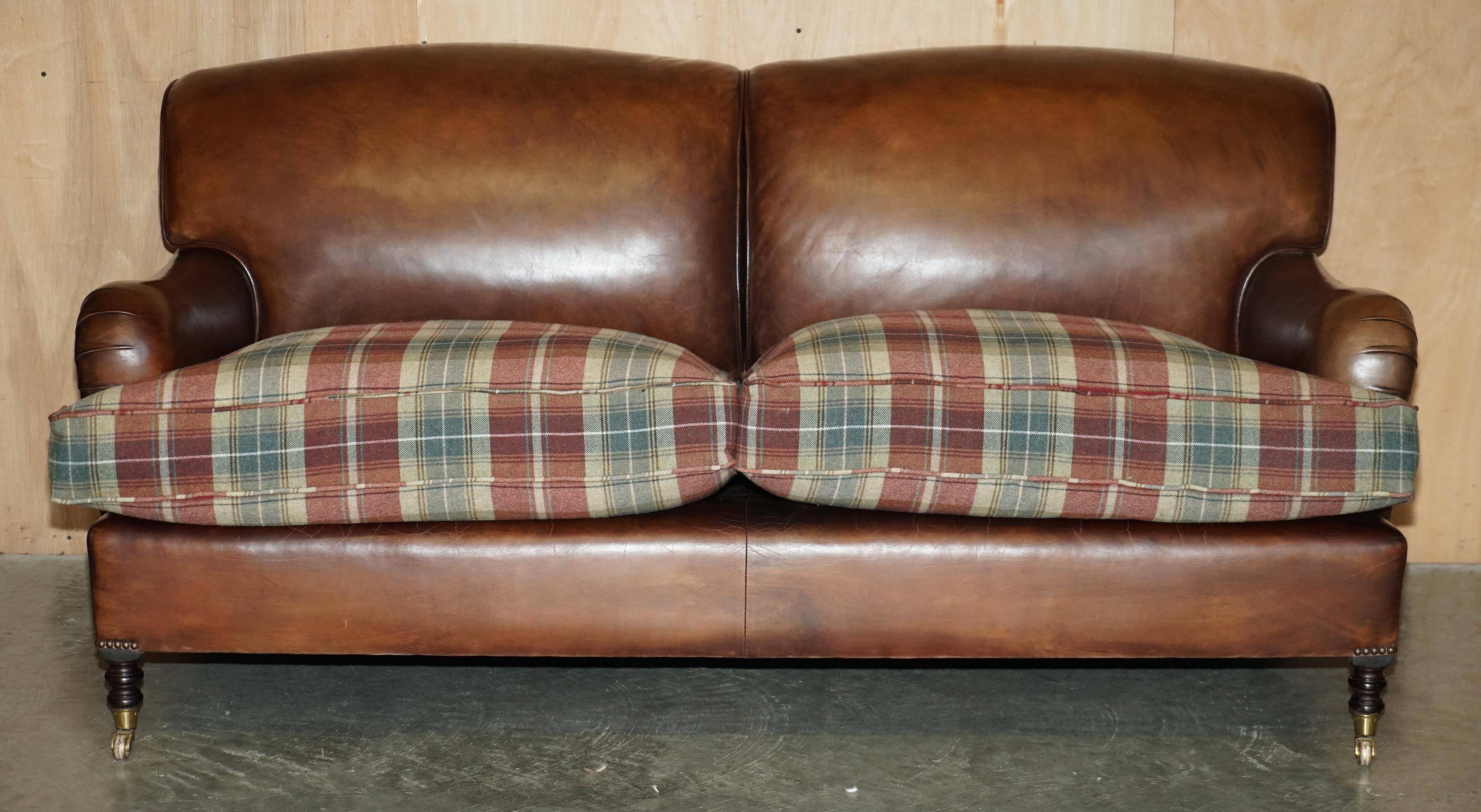 George Smith Signature Scroll leather canapé with tartan Scottish wool cushions.