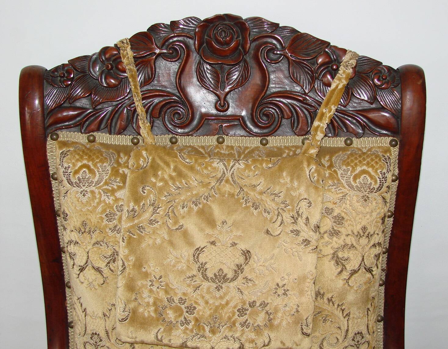 An antique armchair from the turn of the 19th and 20th centuries, carved wa