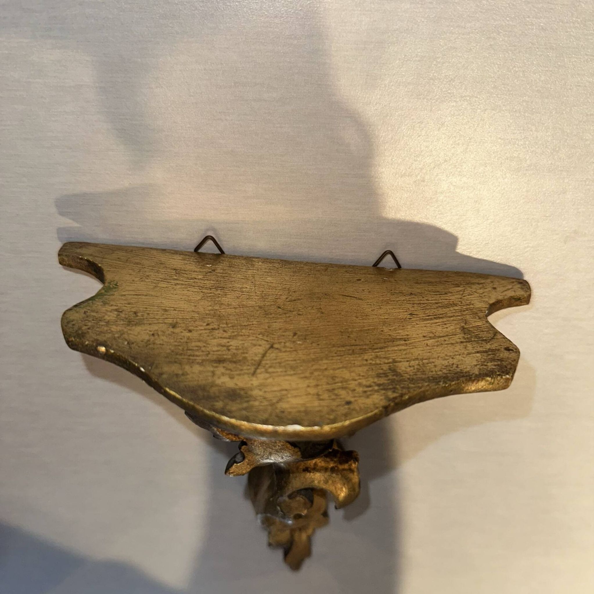 Antique wall-mounted console in gilded wood in rococo style.