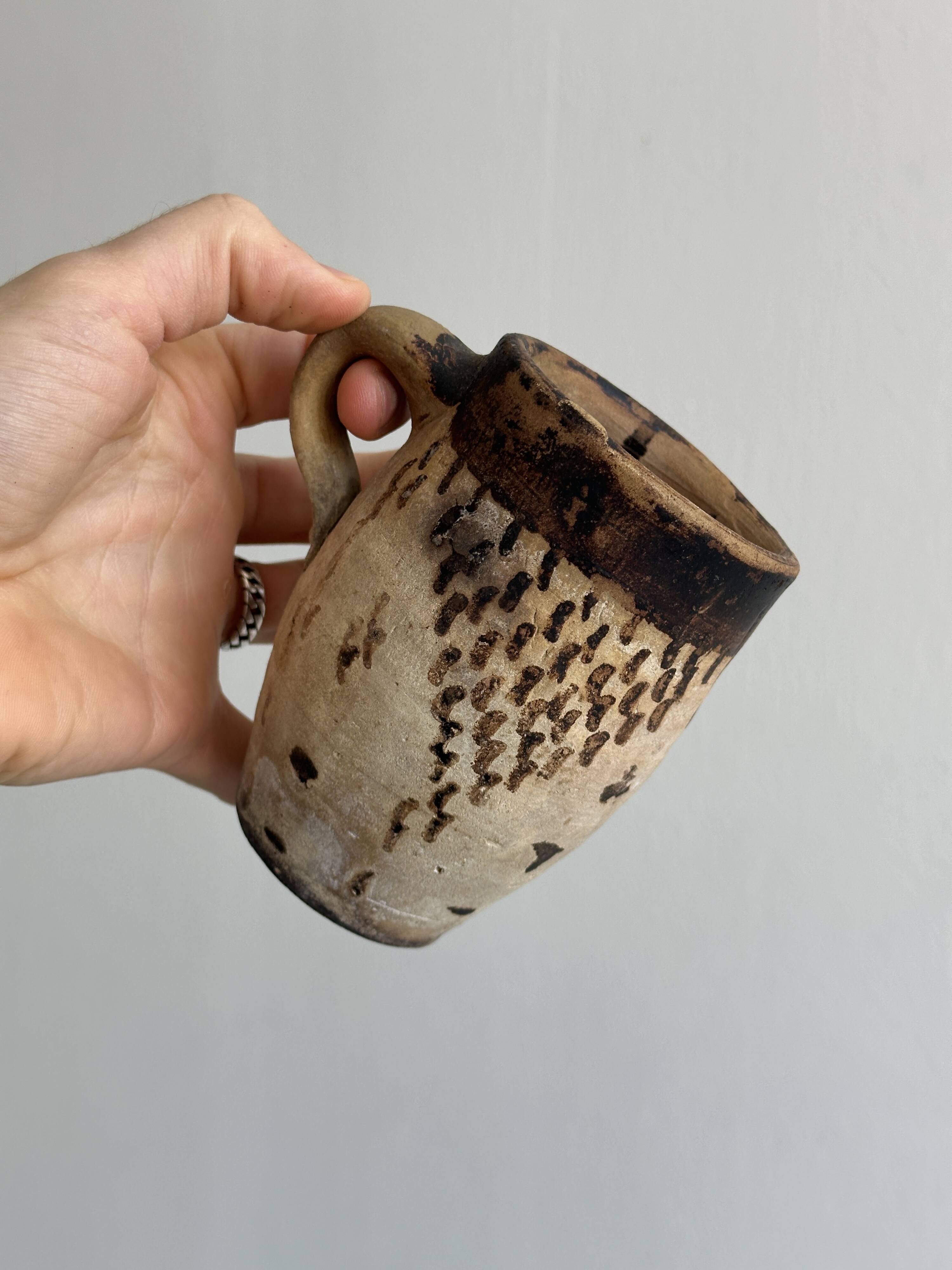 Small old terracotta cup