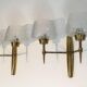 Pair of bronze wall sconces with worked glass reflectors. Stilnovo